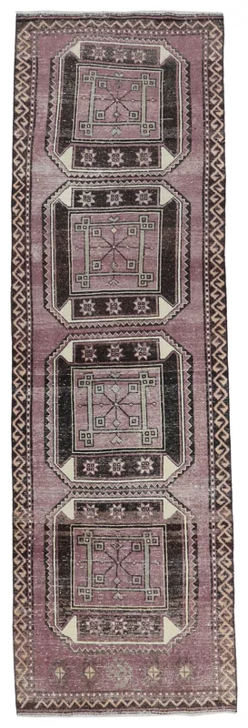 Full overhead view of the vintage purple geometric runner rug on a white background