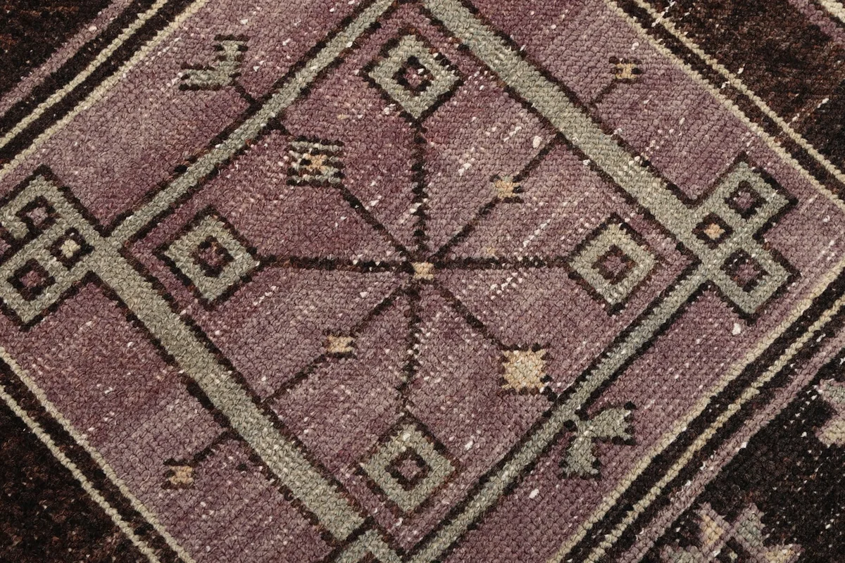 Close-up of a central geometric medallion showing intricate details and color variations