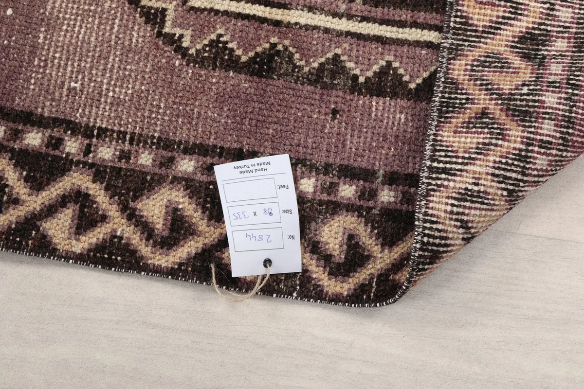 Close-up of the rug's back with a product tag, showing the weave quality