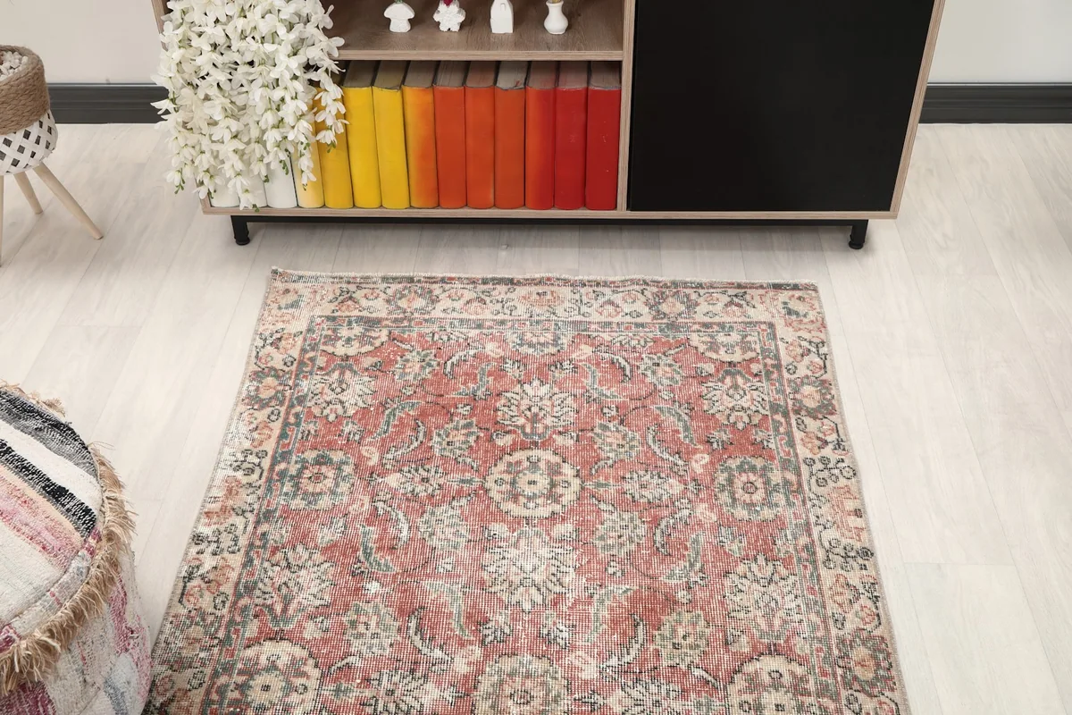 Overhead view of the rose vintage rug in a room, showcasing its placement and size