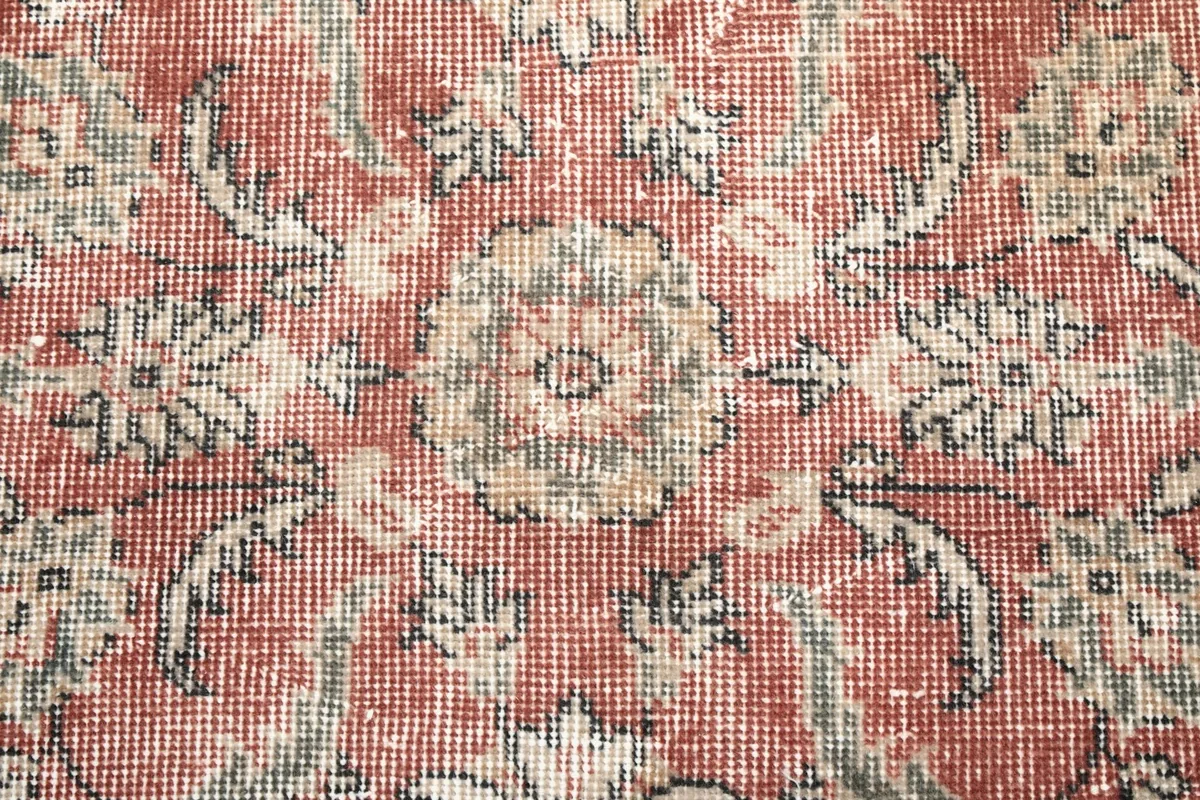Close-up of the low wool pile and intricate knotting, showing the texture and color variations