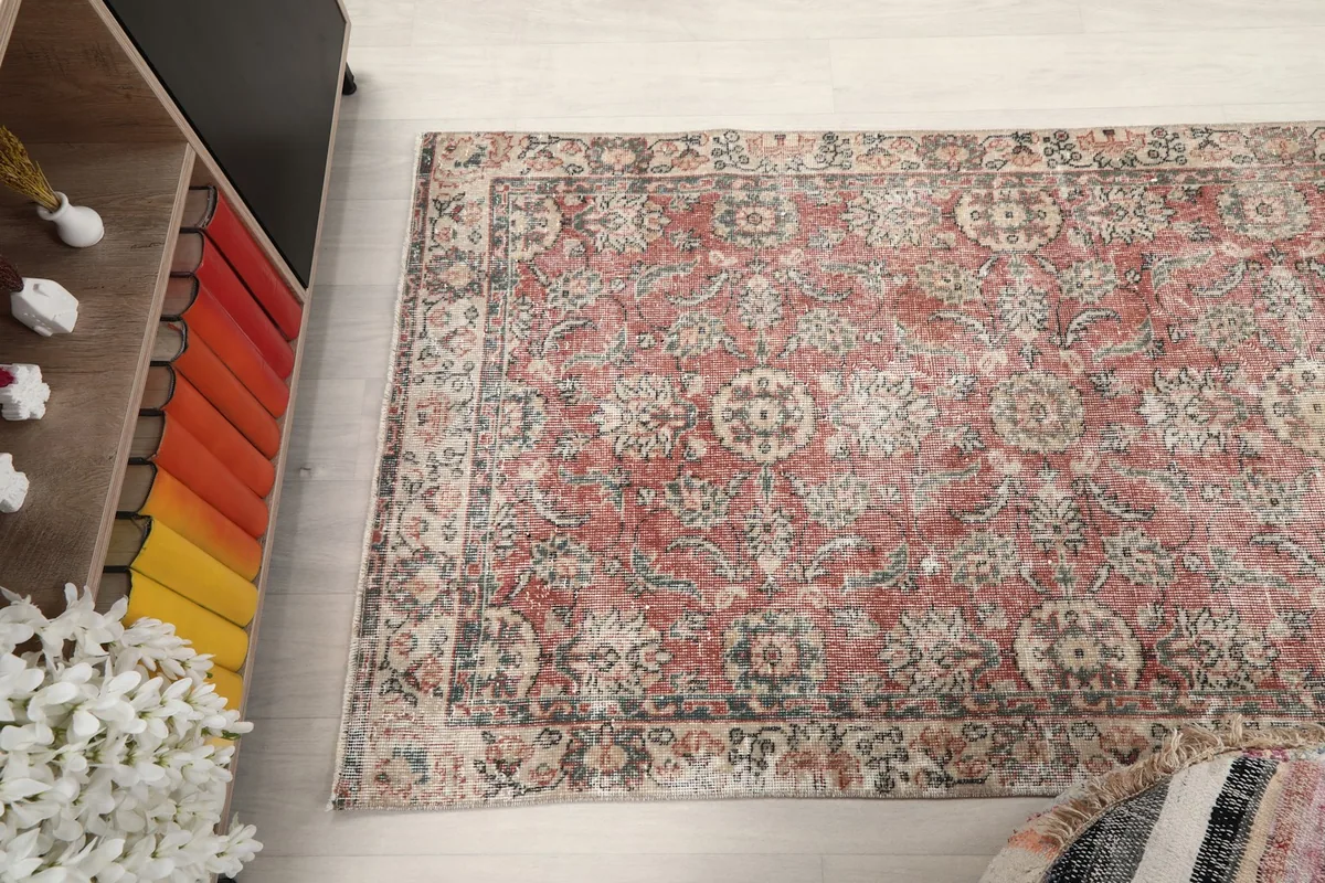Overhead view of the vintage rug from a slightly elevated perspective, showing full pattern