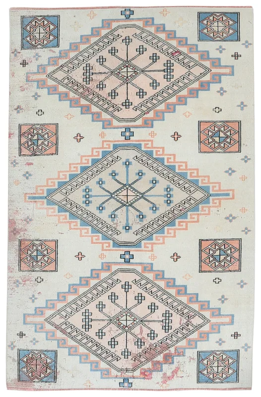 Full top view of the vintage Anatolian rug with ivory, blue, and rose geometric patterns.