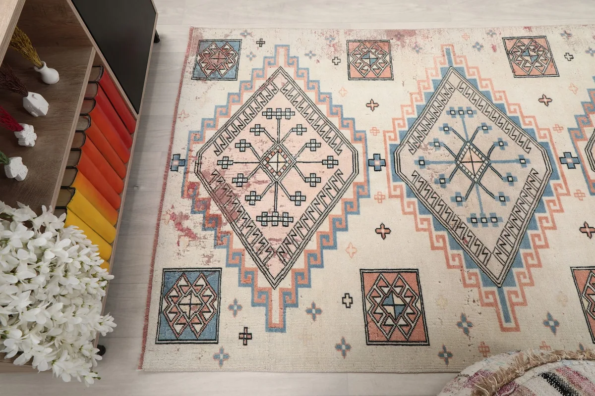 Angled view across the rug, emphasizing the repeat of the geometric designs.