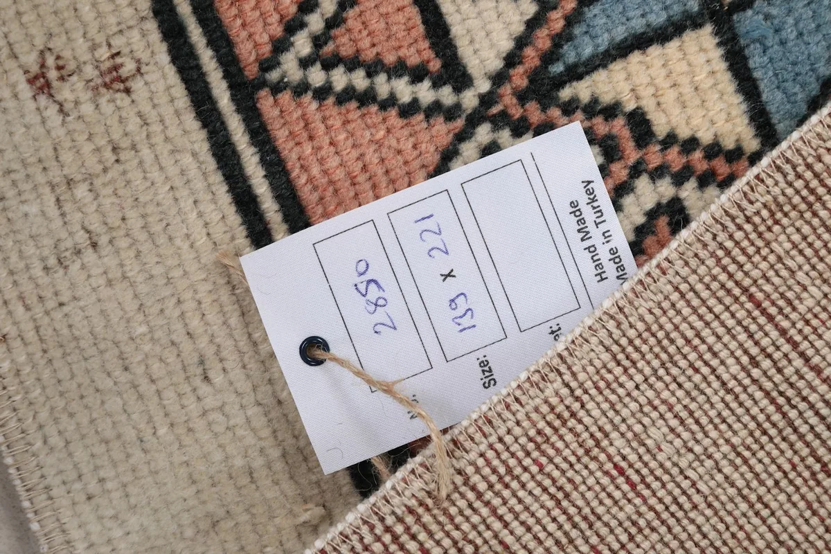 Close-up of the product tag showing the rug's dimensions and origin.