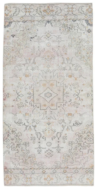 Full top view of an ivory and rose geometric medallion vintage Anatolian rug