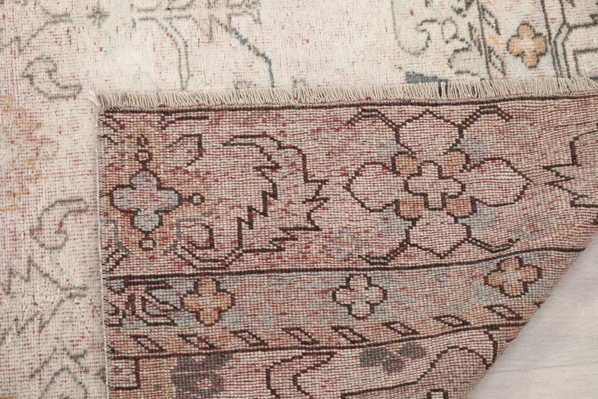 Close-up of the back of the rug, revealing the intricate knotting and cotton foundation
