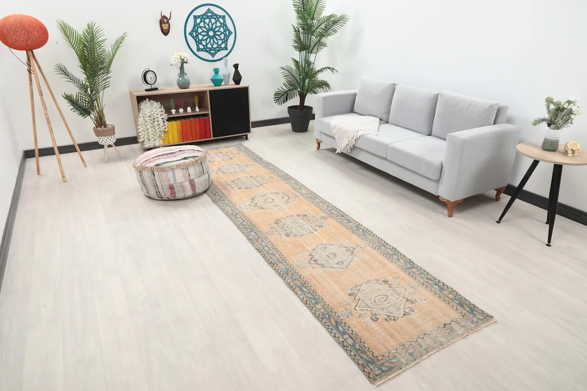 Angled view of the beige runner rug laid out in a contemporary living space with neutral furniture.