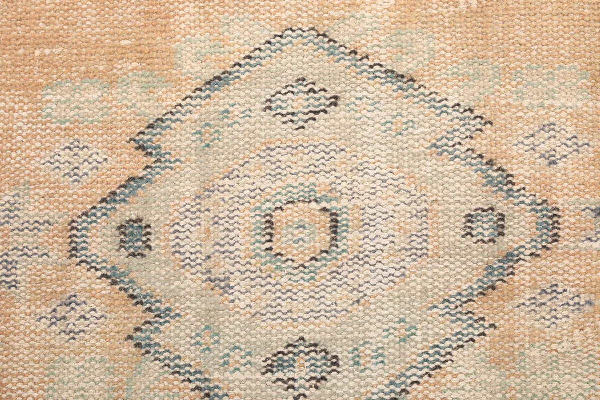 Detailed view of a diamond-shaped tribal motif with subtle color variations and texture.