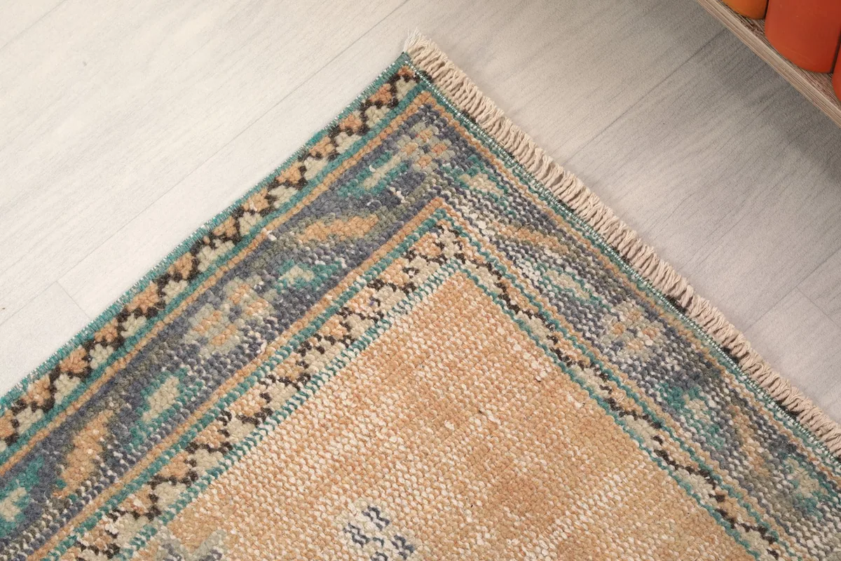 Close-up of the border design at the end of the rug, showing the different patterns and color transitions.