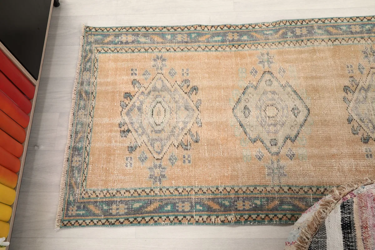 Overhead view of a portion of the rug, displaying multiple geometric motifs along its length.