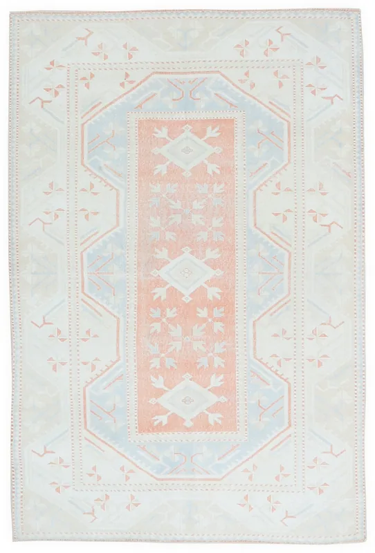 Full overhead view of the cream, blue, and rust geometric vintage Anatolian rug