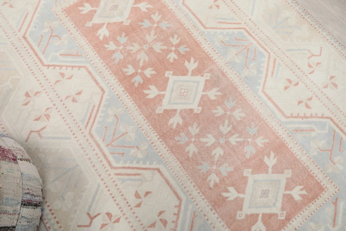 Overhead angle focusing on the faded rust and blue geometric motifs