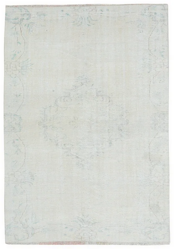 Full overhead view of the ivory vintage Anatolian rug with faded blue medallion and floral patterns.