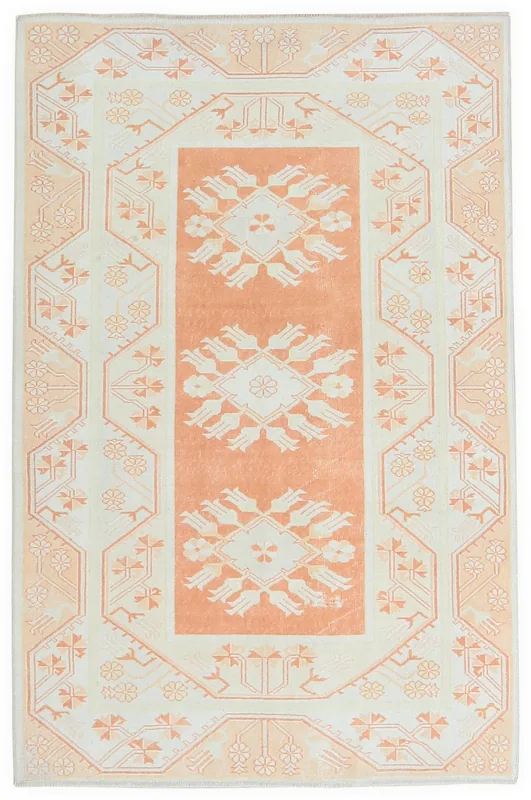 Full top view of the 4'9" x 7'9" vintage Anatolian rug with orange and cream floral geometric patterns.