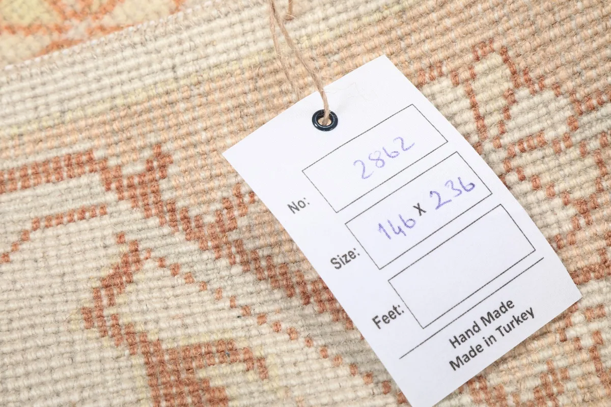 Tag showing the rug's dimensions in centimeters and confirming its hand-made origin in Turkey.