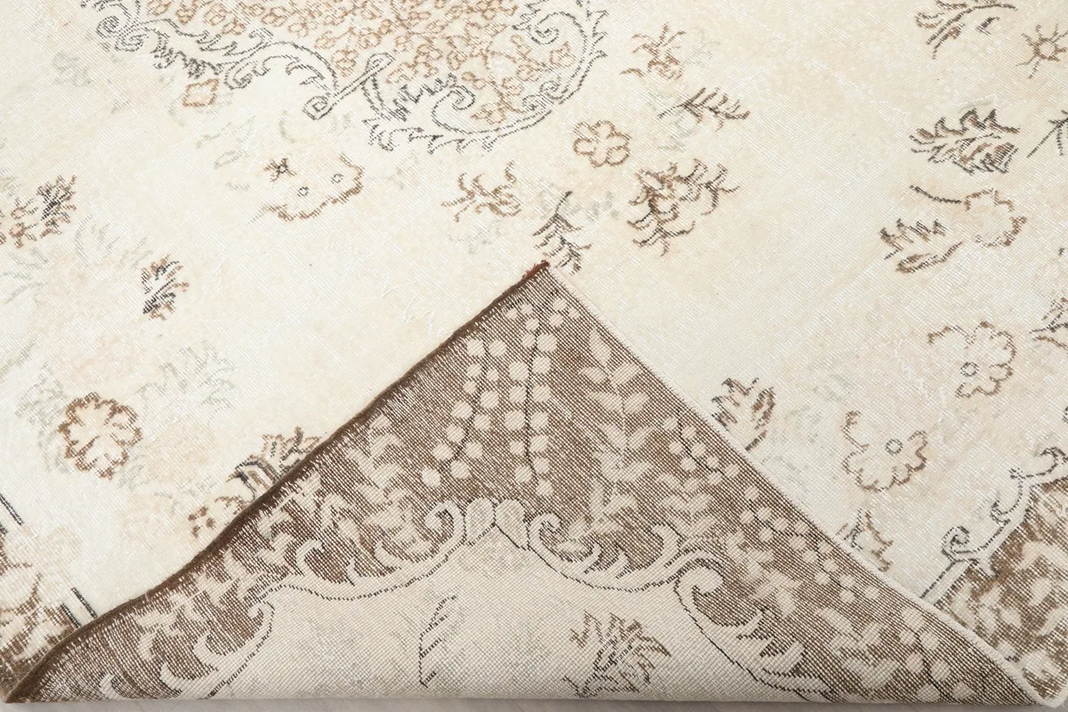 Close-up showing the low wool pile and hand-knotted texture of the vintage rug