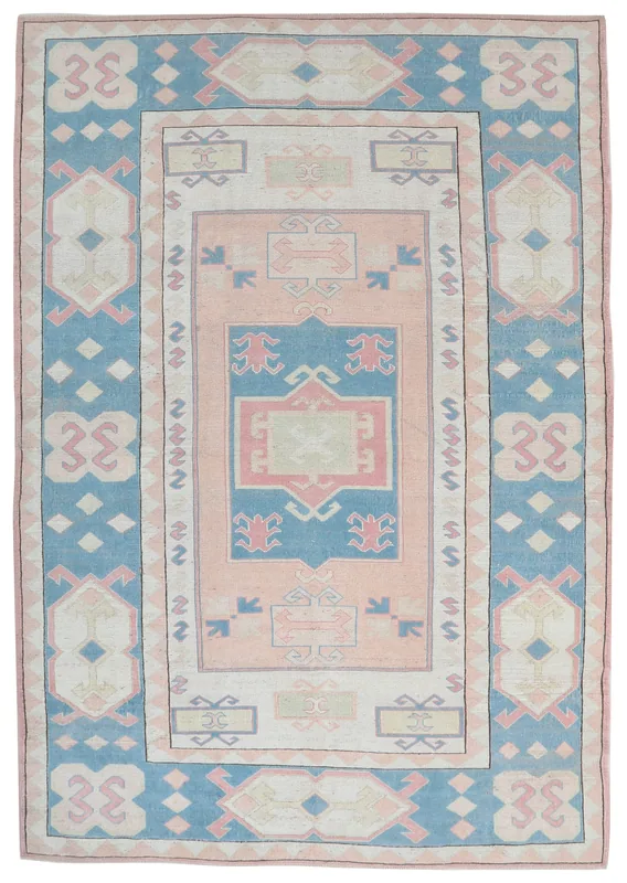 Full overhead view of the 7'5" x 10'6" vintage Anatolian rug with rose and blue geometric patterns
