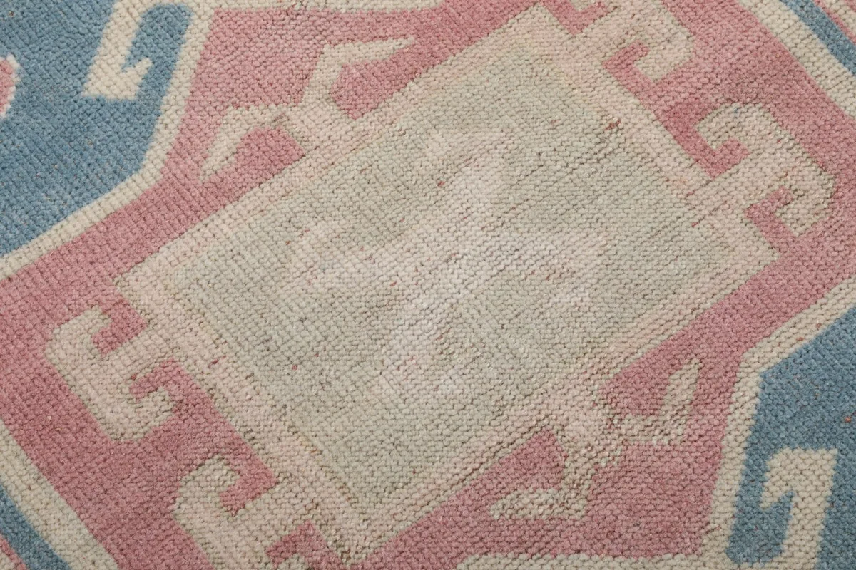Texture detail of the wool pile showing the subtle variations and low height of the rug fibers