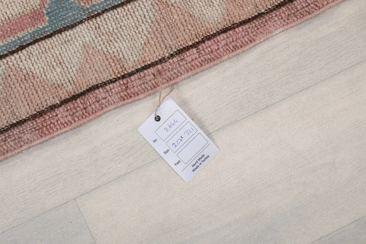 Care label attached to the rug's edge, indicating its origin and material