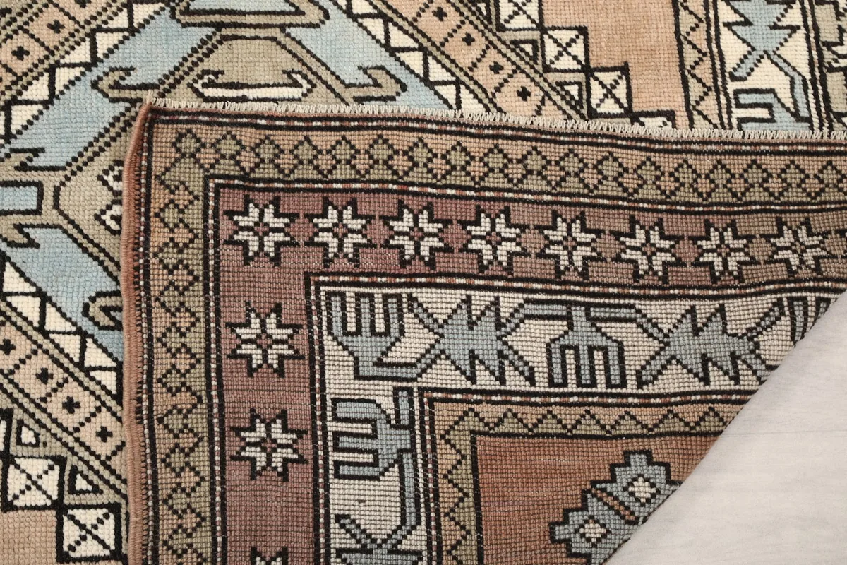 Close-up of the rug's reverse side, showing the cotton foundation and fine hand-knotting.