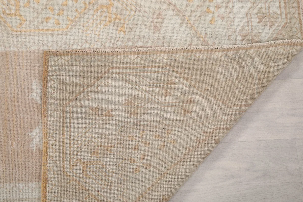 Close-up of the rug's reverse side, showing the intricate knotting and cotton foundation