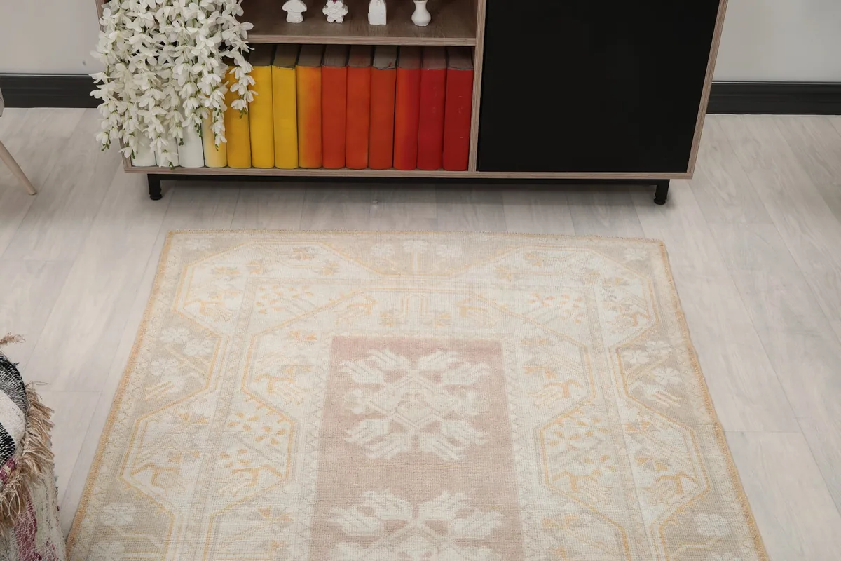 Overhead view showing the rug's position in the room, with a bookshelf in the background