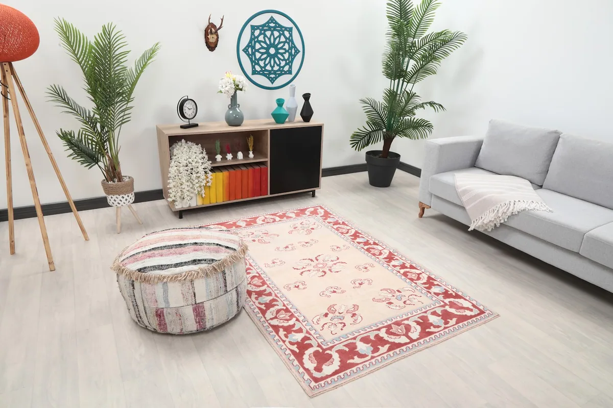 Overhead view of the beige floral rug in a room, showing its placement relative to furniture.