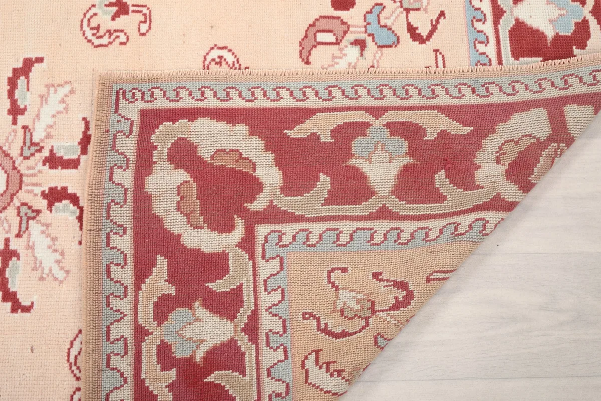 Underside of the rug, showing the cotton foundation and the reverse of the hand-knotted design.