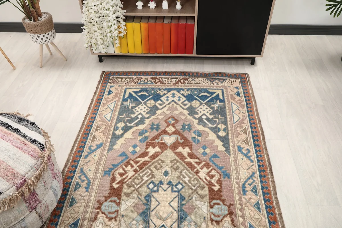 Overhead view of the rug in a room, showing the top half of the design near a console table.