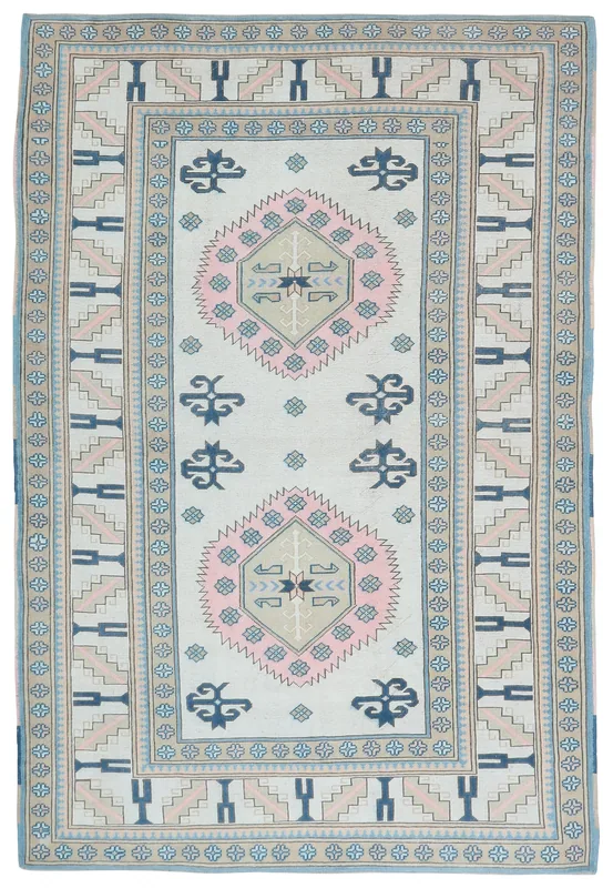Full top view of the ivory, pink, and blue geometric medallion vintage Anatolian rug