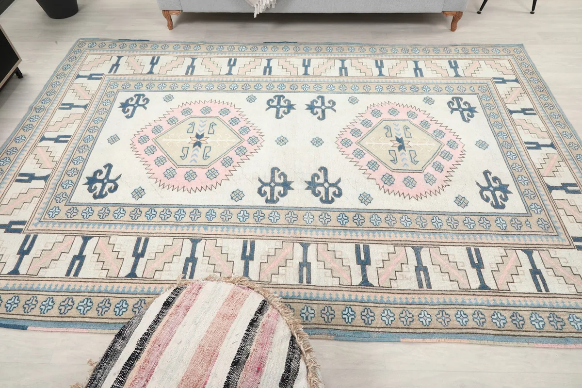 Full overhead view of the vintage rug, showcasing its complete design and colors