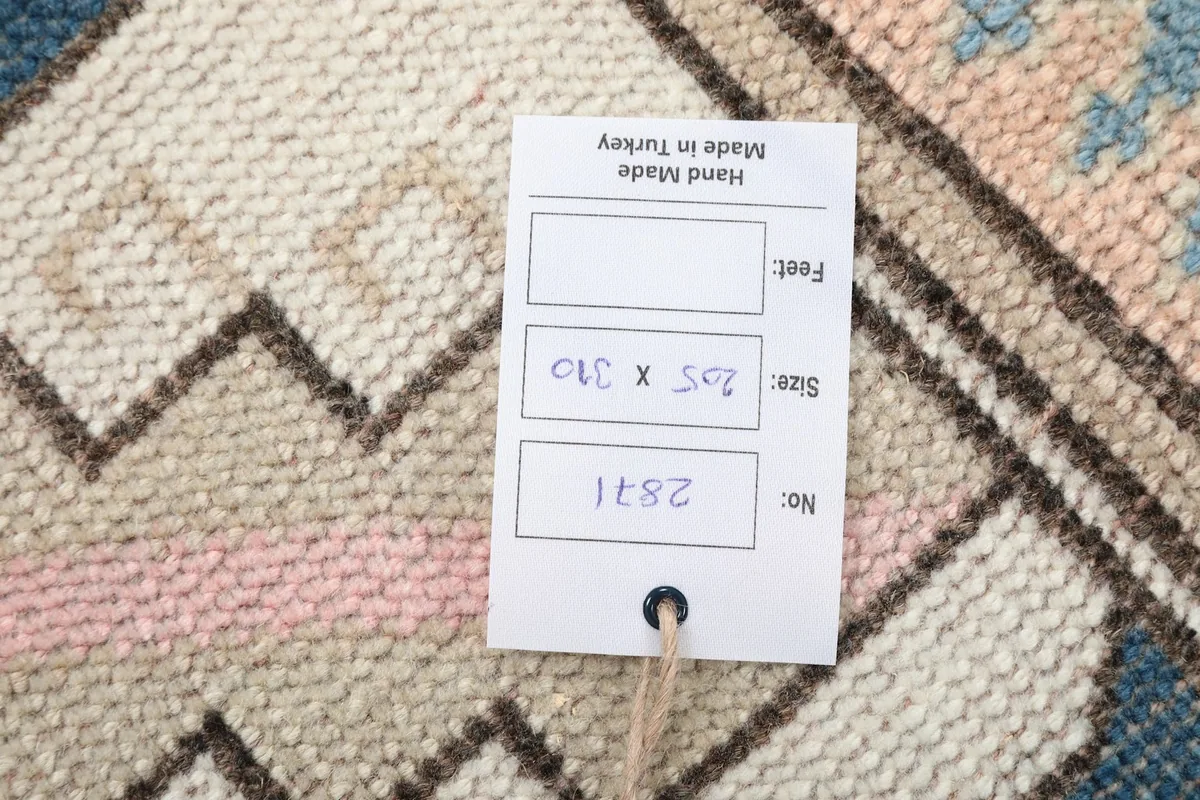 Close-up of the rug's label confirming 'Hand Made in Turkey' and size details