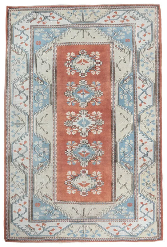 Full top view of the 5'10" x 8'0" rust and blue vintage Anatolian rug on a white background