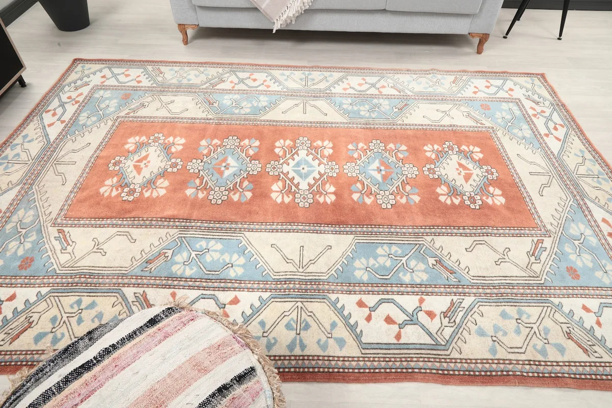 Overhead view of the rug in a living room setup, including a decorative pouf