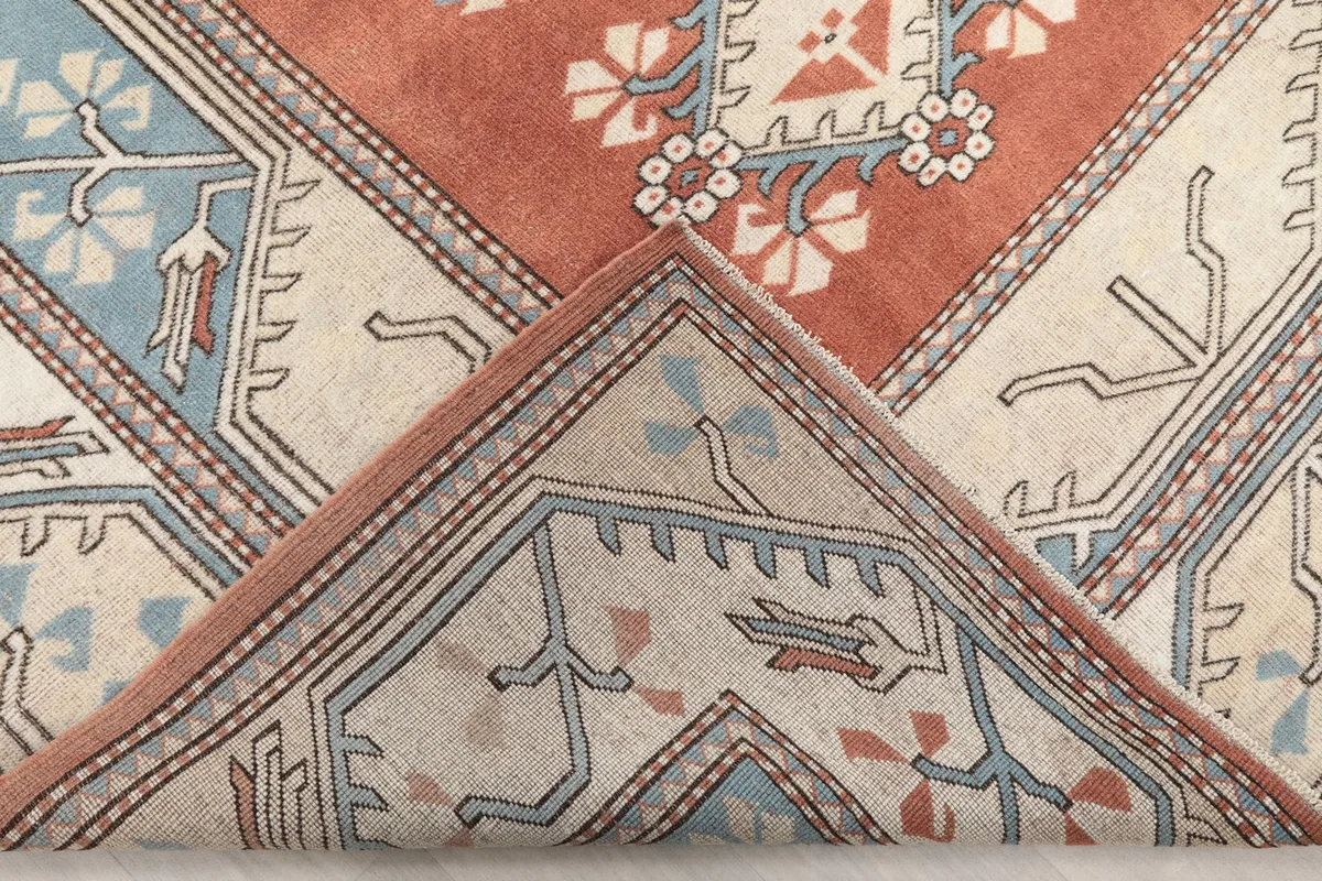 Folded corner of the rug showing the reverse side of the hand-knotted wool pile