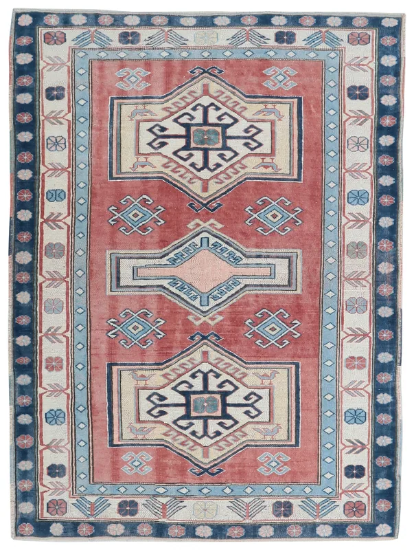 Full overhead view of a vintage Anatolian rug with rust field and navy border