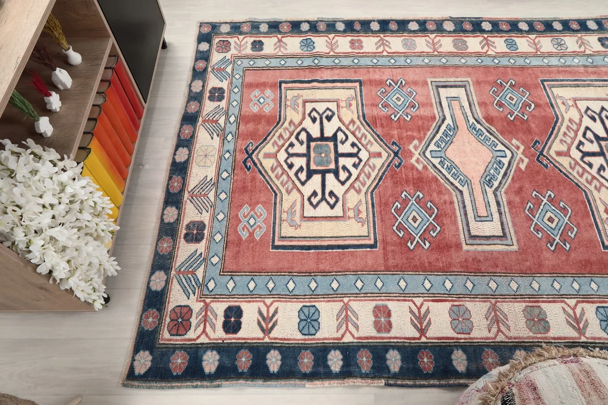 Side angle view of the rug's patterns and colors, extending into the room