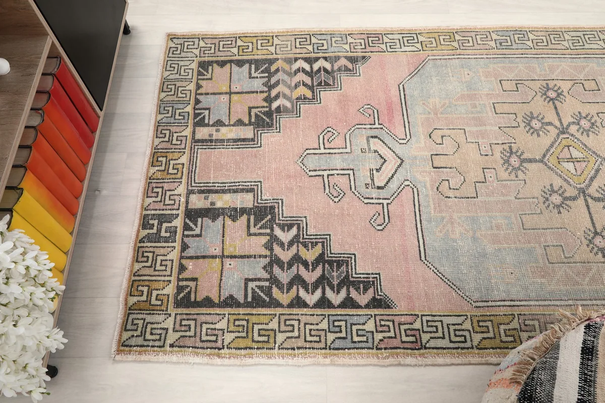 Detailed view of the upper left section of the rug, illustrating the stepped patterns and border