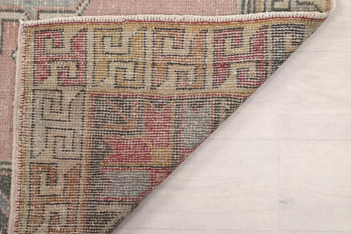 Another view of the folded corner, showing the tight knotting and craftsmanship on the back