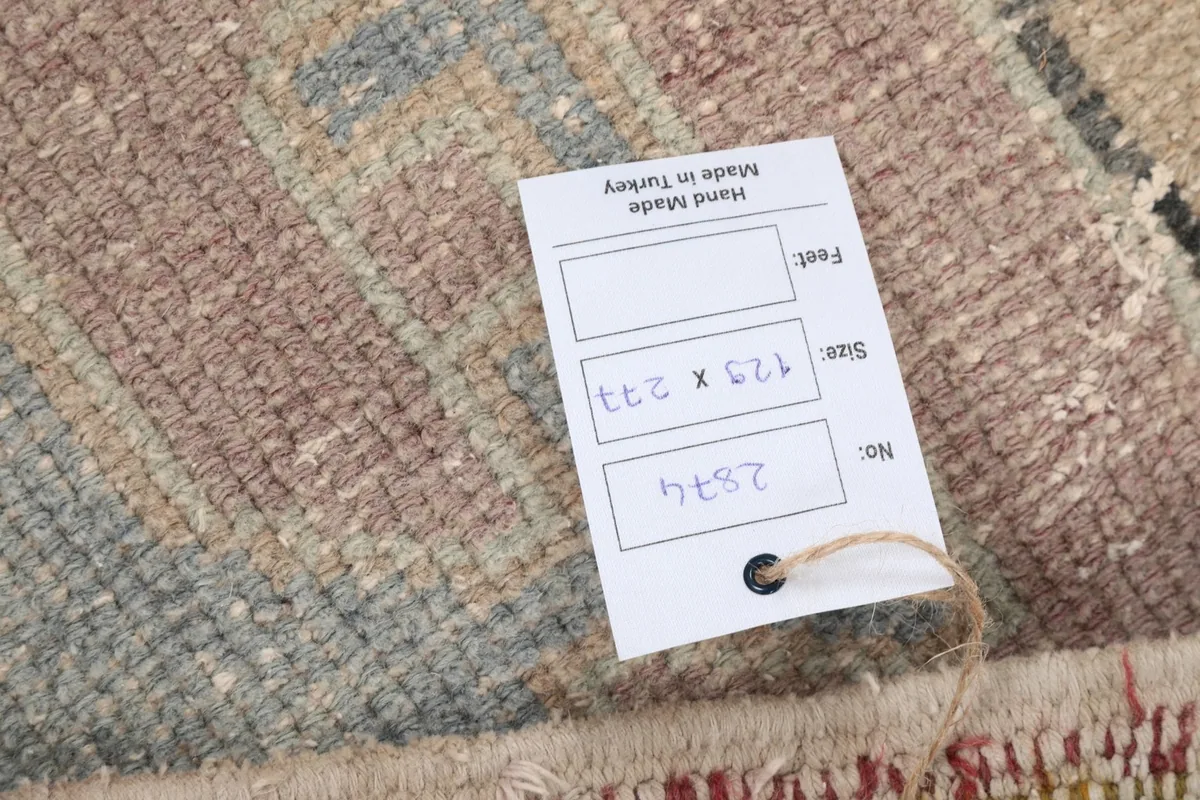 Close-up of the product tag indicating the rug's dimensions and origin