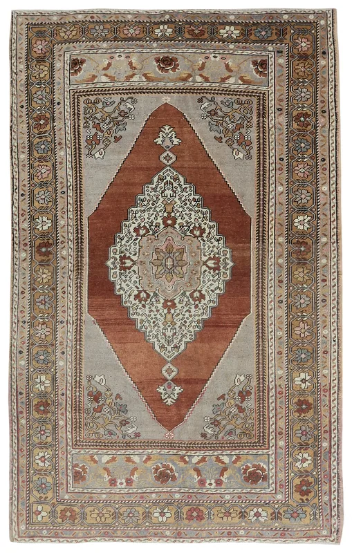 Top view of the 4'10" x 7'11" vintage Anatolian rug with rust medallion and gray field