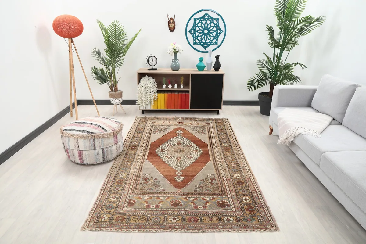 Vintage Anatolian rug in a living room setting with a light gray sofa and modern decor
