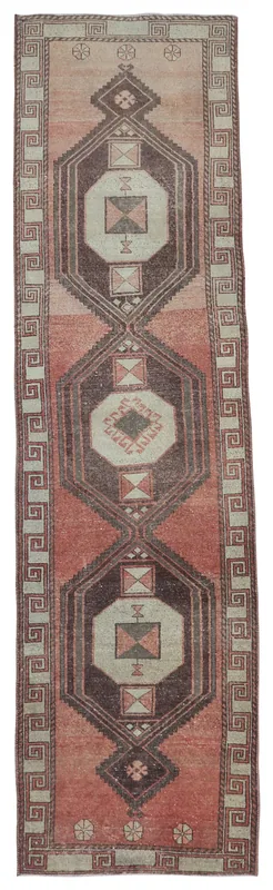 Full overhead view of the rust, brown, and beige geometric Anatolian runner rug on a white background.