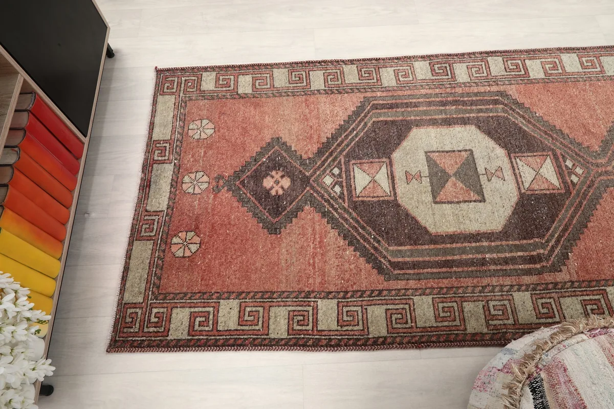 Angled view of the runner rug from above, showing a section of its length and patterns.