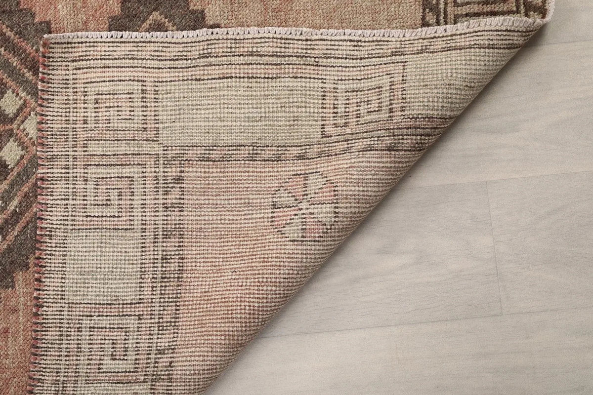 Another view of the rug's underside and cotton foundation, showing the craftsmanship.