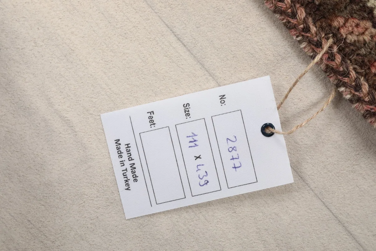 Product tag displaying the rug's dimensions in centimeters and origin as Made in Turkey.