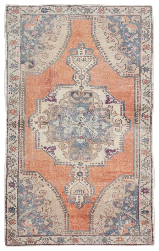 Full top view of the orange and blue vintage Anatolian rug on a white background
