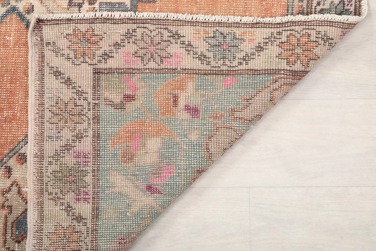 Another folded corner showing the reverse side of the rug and the woven structure