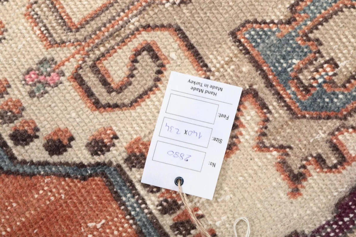 Close-up of the rug's texture with a product tag displaying size and origin